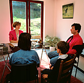Young boy & parents in consultation with GP doctor
