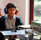 Boy with headphones on having a hearing test