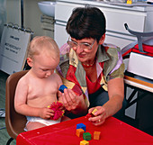 Paediatrician measuring baby's cognitive skills