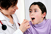 Doctor examining the throat
