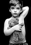 Three-year-old boy with his teddy bear toy