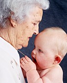 Grandmother holds her infant grandchild