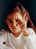 Young girl with an aggressive and angry expression