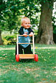 Young boy taking his first steps