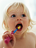 Baby girl brushing teeth