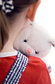 Young girl holding a cuddly toy