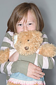 Girl hugging her teddy bear
