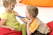 Children playing with a toy stethoscope