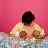 Mother breast-feeding her twins at the same time