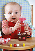 Baby with bottle of juice