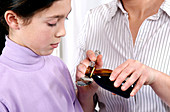 Child taking cough syrup