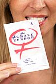 Woman with a female condom packet
