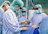 Surgeons using a laser during heart surgery