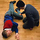 First aiders practice recovery position