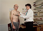 Doctor examines elderly man with stethoscope