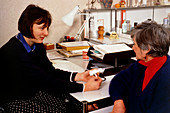 Doctor with woman patient: Clinistix urine test