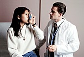 Patient learning to use an inhaler with GP