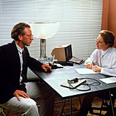 Man in consultation with GP doctor