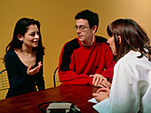 Young couple in consultation with GP doctor