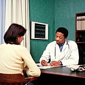 GP doctor writes prescription for a female patient