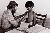 Doctor examines refugee child