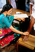 Doctor examing patient at filariasis clinic