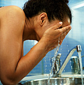 Woman rinsing her face