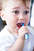 Young boy brushing his teeth