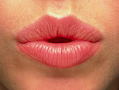 Close-up of the pink lips of a woman (front view)