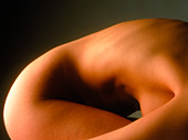 Side view of the torso/hip of a woman crouching