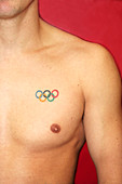 Man's chest with an Olympic tattoo