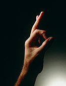Male hand: thumb and forefinger forming an O