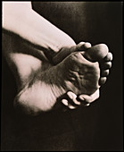 Healthy sole of the foot held by a woman's hand