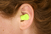 Woman wearing an earplug