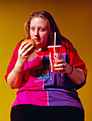 Adolescent girl eating fast food