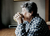 Elderly woman drinking
