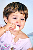 Young boy eating a sweet