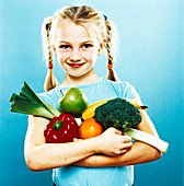 Girl holding fruit and vegetables