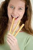 Woman eating bread sticks