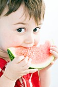 Toddler eating watermelon