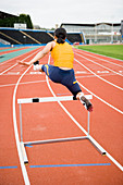 Athlete clearing a hurdle