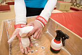 Gymnast rubbing hands with chalk