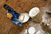 Making maize flour,Uganda