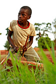 Boy playing a drum,Uganda