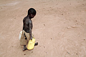 Ugandan boy carrying water