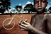 Boy holding a model bicycle,Uganda