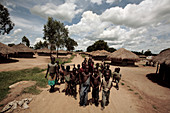 Children walking along a road,Uganda