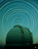 Time exposure of star trails over dome