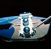 Compton Observatory satellite with Shuttle arm