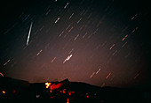 Photo of night sky showing a Geminid meteor
